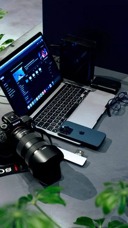 Creative editing workspace with camera and laptop